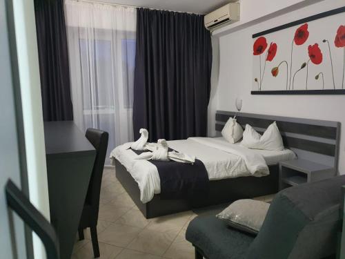 a hotel room with a bed with two birds on it at Vila Blue Lagoon in Eforie Nord
