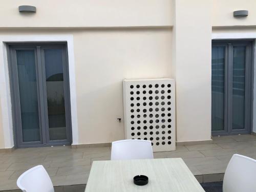 a table and chairs in front of a building at Selena Villa in Kamari