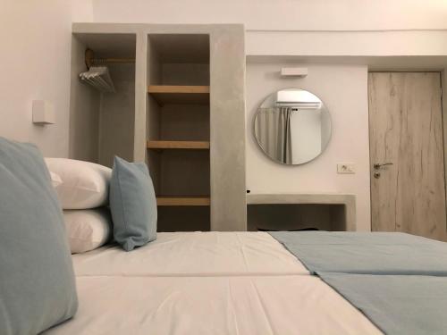 a bedroom with a large bed and a mirror at Selena Villa in Kamari