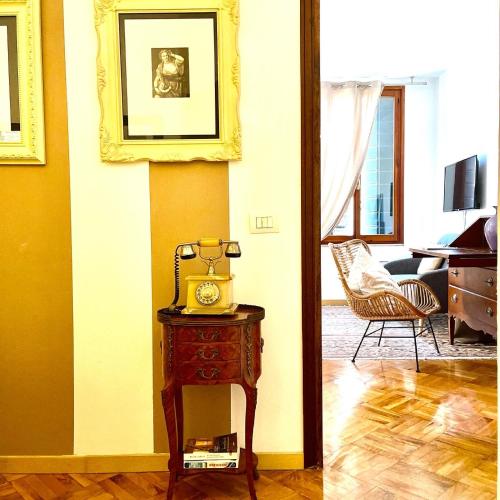 a room with a table with a clock on it at Palazzina300 in Treviso