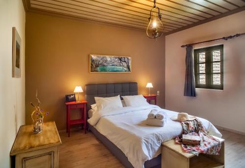a bedroom with a large bed and two tables at Zissis Hotel in Aristi