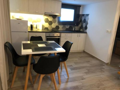 a kitchen with a table and chairs in a room at Selena Villa in Kamari
