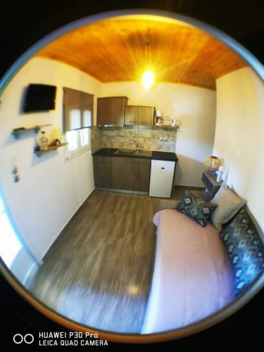 a circular view of a kitchen and a living room at Ktima Mimoza in Sikia