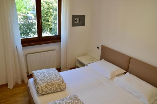 Ένα ή περισσότερα κρεβάτια σε δωμάτιο στο Appartamento AL CENTRO