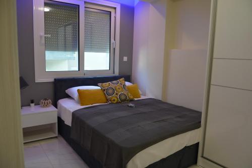 a small bedroom with a bed and a window at Princess Luxury Suite 2 in Paralia Katerinis