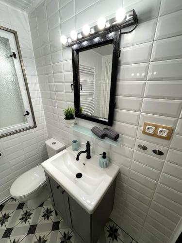 a bathroom with a sink and a toilet and a mirror at Zegzug Noszvaj in Noszvaj