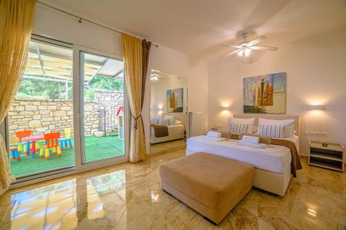 ein Schlafzimmer mit einem Bett und einer Glasschiebetür in der Unterkunft Villa Hera-The infinity blue in Nisaki