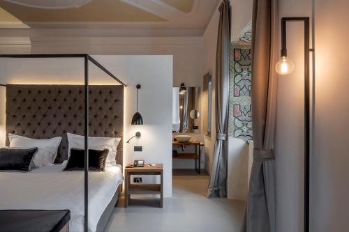 a bedroom with a canopy bed and a table at Castel Hörtenberg in Bolzano