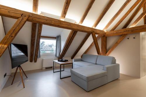 a living room with a couch and a tv at Castel Hörtenberg in Bolzano