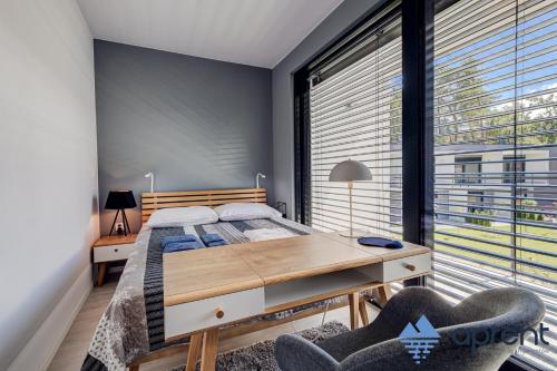 a bedroom with a bed and a large window at Dom FANØ Baltic 2 - Aprent in Pobierowo