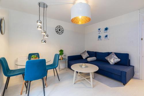 a living room with a blue couch and a table at Stunning 2 Bedrooms Apartment Next Door To Selfridges and Oxford Street in London