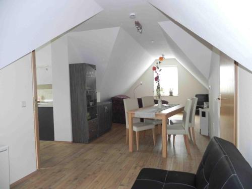 a dining room and kitchen with a table and chairs at Ferienwohnungen am Unstrutwehr in Freyburg