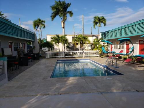 a swimming pool with a slide and a playground at Georges Royal Inn in Frederiksted