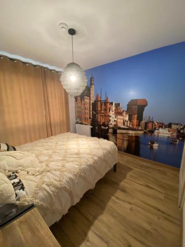 a bedroom with a large wall mural of a city at APARTAMENT nad MOTŁAWĄ LUŚKA in Gdańsk