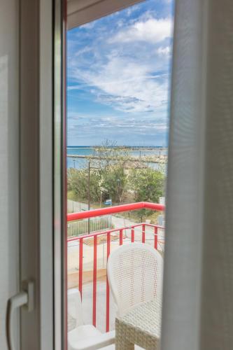 a room with a balcony with a view of the ocean at Hotel Marylise in Rimini