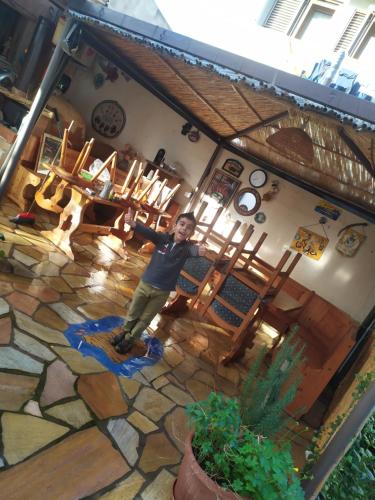 a man standing in a room with a stone floor at B&B Zia Delia in Villaperuccio