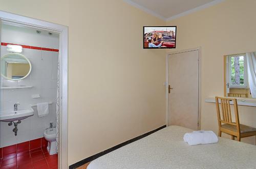 a small bathroom with a sink and a toilet at Hotel Storyville - svago e convenzioni aziendali in Cinquale