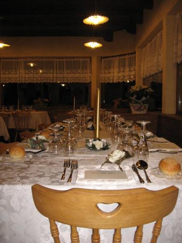 a long table with plates and silverware on it at Albergo Chalet Lago Antorno in Misurina