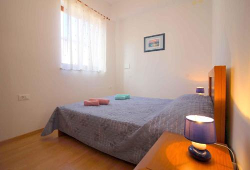 a bedroom with a bed and a table with a lamp at Apartment in Porec/Istrien 10068 in Poreč
