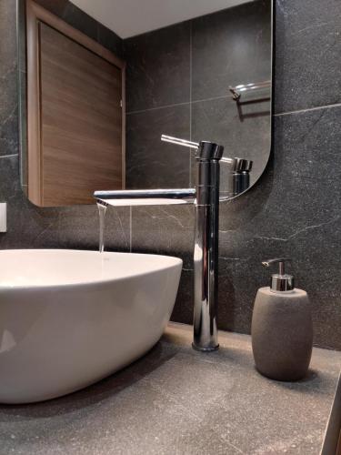 a bathroom with a sink and a mirror at Mare Monte Luxury Apartments 3 in Nea Skioni