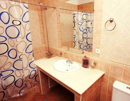 La salle de bains est pourvue d'un lavabo et d'une douche. dans l'établissement Résidence Jawhara Smir à Marina Smir, à M'diq