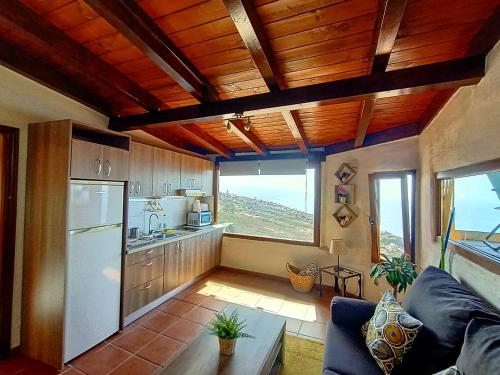 a living room with a refrigerator and a kitchen at Apartamento Maudes de StarApsTenerife in Sauzal