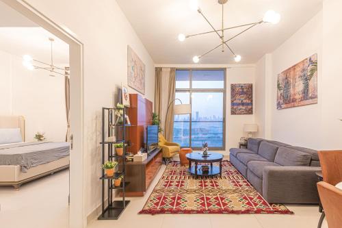 a living room with a couch and a table at Pearl Island, Meydan - 1bdr Apartment in Dubai