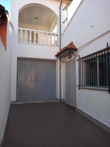 a building with a garage door and a gate at Ca Pepet in Adzaneta de Albaida