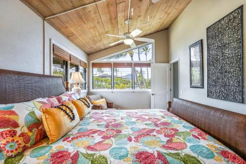 a bedroom with a bed and a ceiling fan at Makahuena at Poipu in Koloa