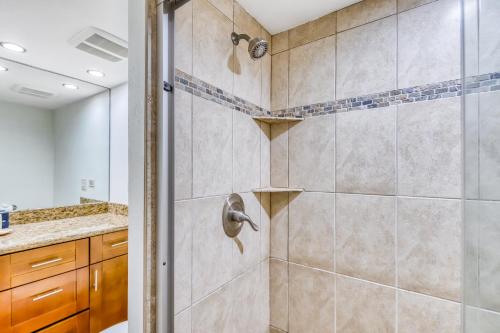 a bathroom with a shower with a glass door at Nohonani 306 in Kahana