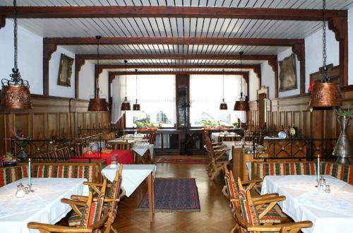a dining room with white tables and chairs in it at Hotel zur Post in Bacharach