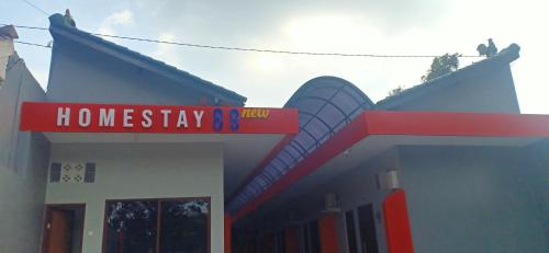 a house with a sign that reads homesteadery and yard at Homestay 89 New in Jepara