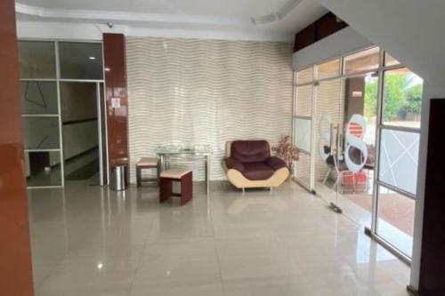 a living room with a chair and a table at RedDoorz Plus Syariah @ Jalan Syiah Kuala Banda Aceh in Lheue