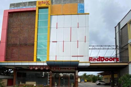 a building with a building with a sign on it at RedDoorz Plus Syariah @ Jalan Syiah Kuala Banda Aceh in Lheue