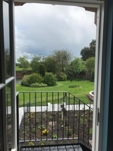 a view from a window of a yard at Cockloft Romantic Countryside Hideaway in Bishops Cannings