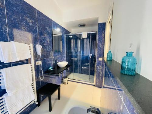 a bathroom with a tub and a glass shower at Ravello 23 Accommodation in Ravello