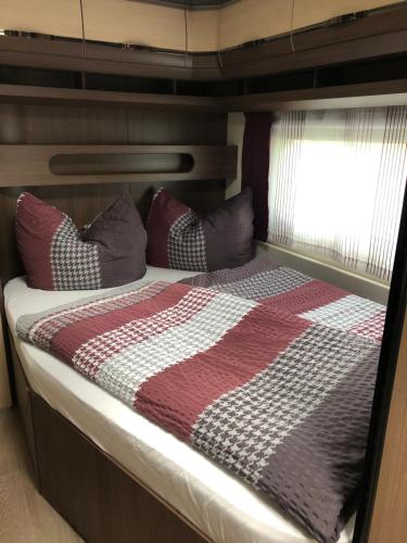 a bed in the back of a boat at Prestige Camping Brandenburg in Plaue