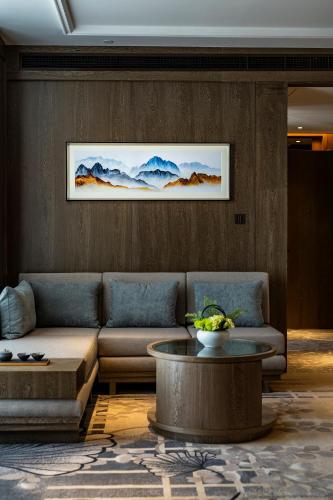 a living room with a couch and a table at Jinling Grand Hotel in Chongqing