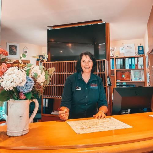 a woman sitting at a table with a map at Hotel Bayrischer Hof in Wels
