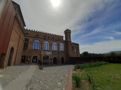 a large brick building with a clock tower on it at Alloggio Turistico Sutri in Sutri