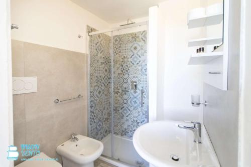 a bathroom with a shower and a sink and a toilet at La Marea in Castro di Lecce