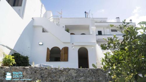 a white house with stairs in front of it at La Marea in Castro di Lecce