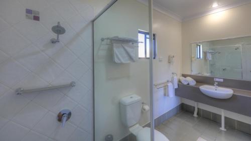a bathroom with a toilet and a sink and a shower at Best Western Ascot Lodge Motor Inn in Goondiwindi