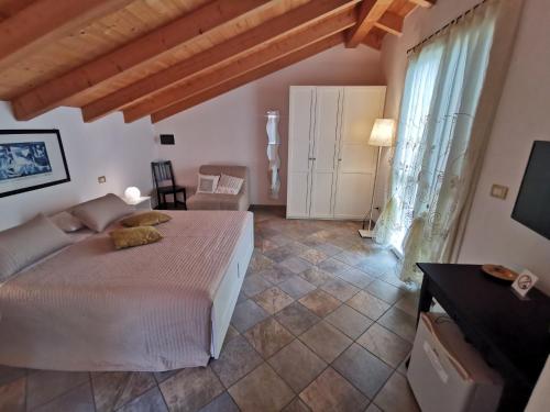 a bedroom with a bed and a couch and a television at Le Fiabe in Sestri Levante