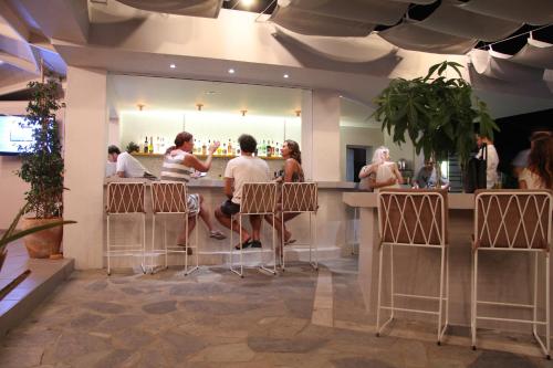 
people sitting at tables in a restaurant at Seaside Suites in Kavos
