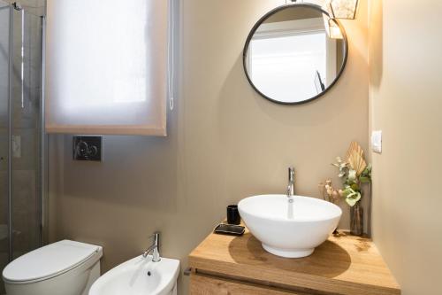 a bathroom with a sink and a mirror and a toilet at Nest House & Relax in Civitanova Marche
