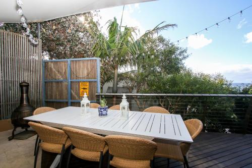 a white table and chairs on a deck at Saltwater 5 - sleeps 8 - close to Main Beach in Point Lookout
