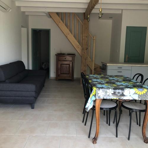 a living room with a table and a couch at Manoir de Champvert in Les Vans