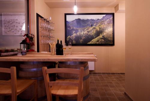 a bar in a restaurant with a painting on the wall at Hotel SLUNEČNÁ LOUKA in Lipno nad Vltavou