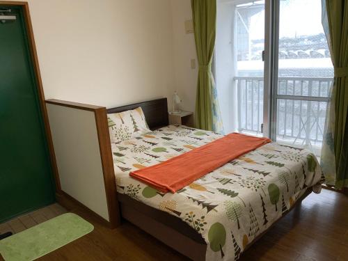 Postel nebo postele na pokoji v ubytování Asahi21 Asahibashi-Ekimae